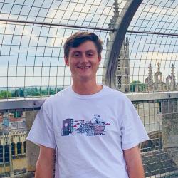 Summer Programmes student Robert smiling on top of a roof in cambridge