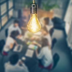 Lightbulb above a group of people to represent entrepreneurship