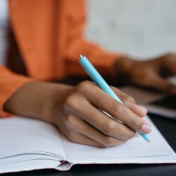 Person writing in notebook