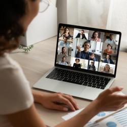Person studying for an online course with other students on screen