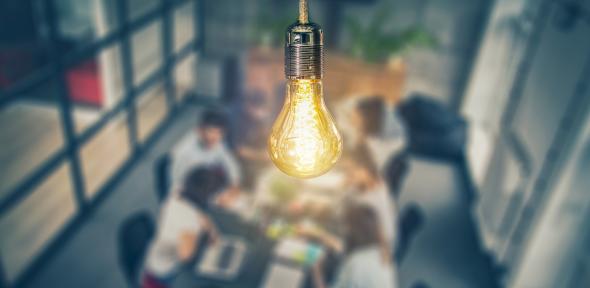 Lightbulb above a group of people to represent entrepreneurship