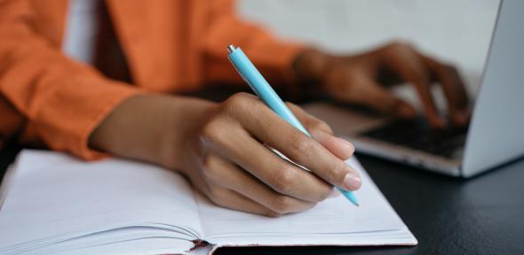 Person writing in notebook