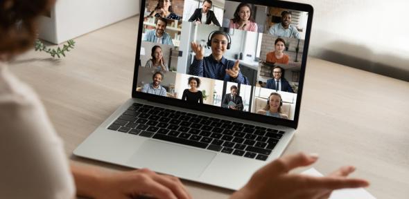 Person studying for an online course with other students on screen