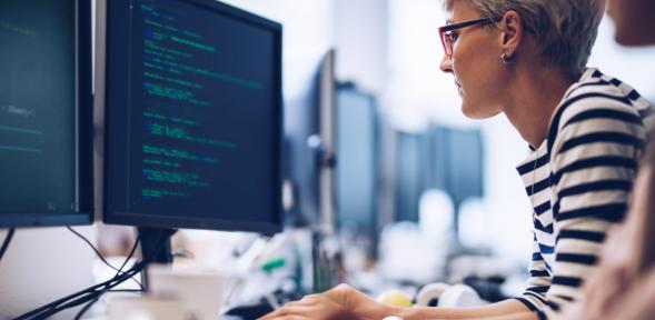 Woman on computer doing data programming