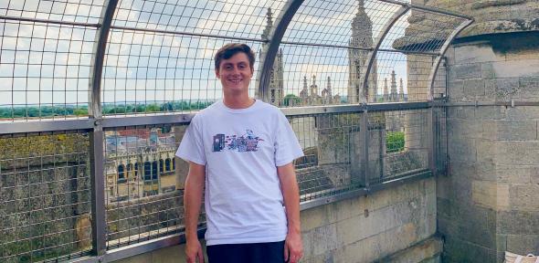 Summer Programmes student Robert smiling on top of a roof in cambridge
